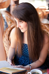 Beautiful woman reading a book in the cafe