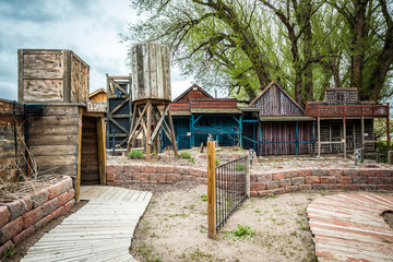 Small old town with wooden buildings and entrance to a mine