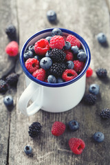 metallic mug with fresh forest berries