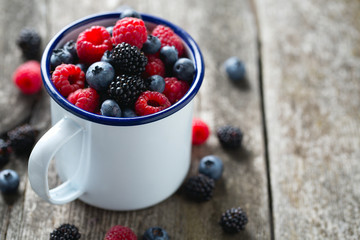 metallic mug with fresh forest berries