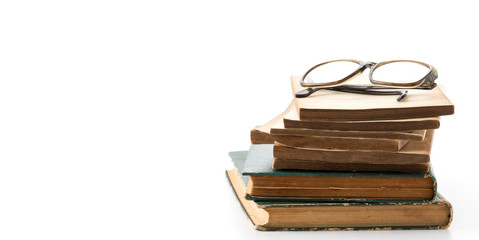 old book with glasses on white background