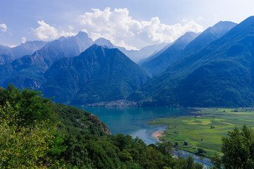 Naklejka na ściany i meble Lago di Mezzola Lake landscape. Water and mountains. Lombardy, Italy, Europe. 