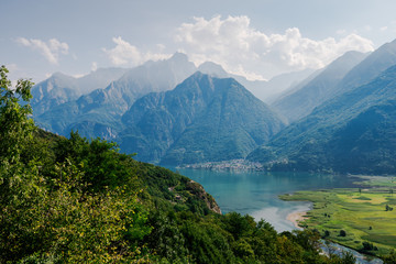 Naklejka na ściany i meble Lago di Mezzola Lake landscape. Water and mountains. Lombardy, Italy, Europe.