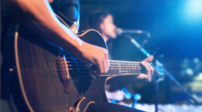 Guitarist on stage for background, soft and blur concept