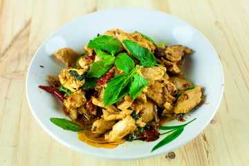 Spicy Thai basil chicken ready to eat on traditional plate