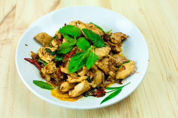 Spicy Thai basil chicken ready to eat on traditional plate