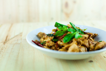Spicy Thai basil chicken ready to eat on traditional plate
