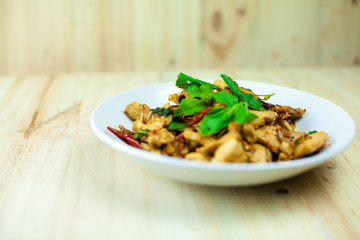 Spicy Thai basil chicken ready to eat on traditional plate