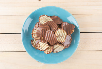 potato chip with chocolate on wood