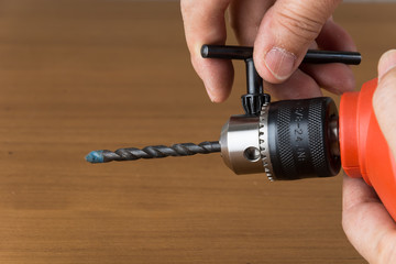 orange drill on wood background