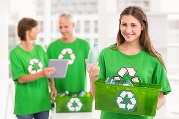 Smiling eco-minded woman holding recycling box