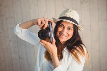 Pretty hipster using her vintage camera