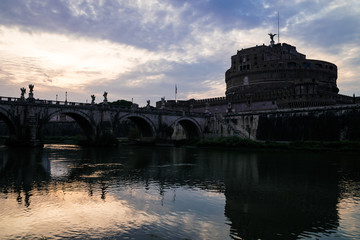 View on bridge over the Tiber river and Saint Angel castle after sunset,  Rome, Italy.