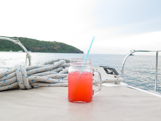 Colorful cocktail drink on  sea & sky background