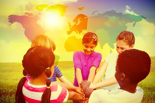 Composite image of children holding hands together at park