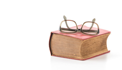 old book with glasses on white background