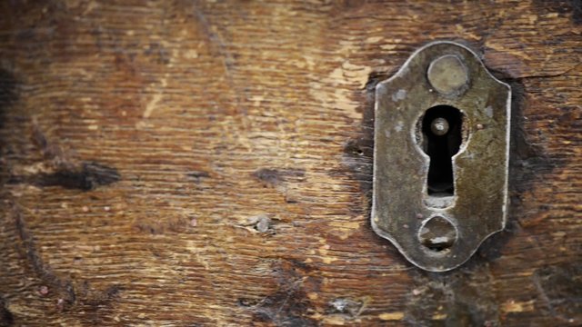 Vintage metal lock on old wooden chest