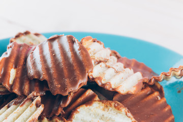 potato chip with chocolate on wood