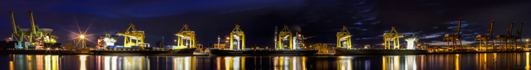 Container Cargo freight ship with working crane loading bridge i