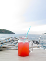 Colorful cocktail drink on  sea & sky background