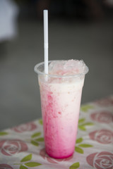Thai pink tea with milk in plastic glass