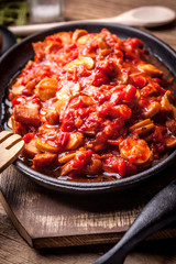 Stew with peppers, onions and sausages.