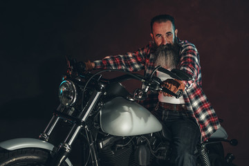 Fototapeta na wymiar Casual cool long beard man on motorcycle.