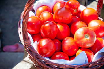 Red tomato in a wicker basket