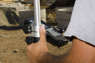 Geodesist with gps at a countryside stadium