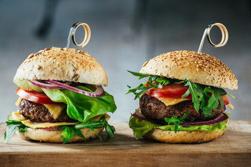 Delicious burgers with beef, tomato, cheese and lettuce
