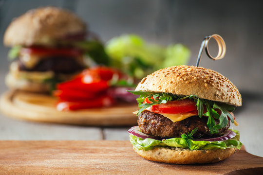 Delicious burgers with beef, tomato, cheese and lettuce
