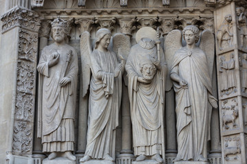 Fototapeta na wymiar Paris - West facade of Notre Dame Cathedral. The Virgin Mary portal .
