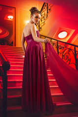 woman in a long dress lying on the stairs