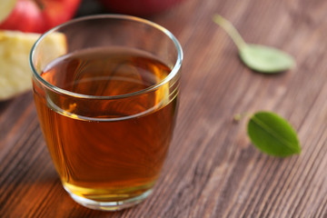 Glass of apple juice and fruits on table close up