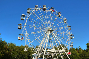Ferris wheel against bright blue sky