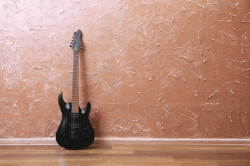Electric guitar on brown wall background