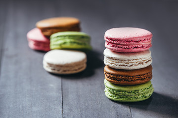 Colourful tasty macaroons on a wooden table