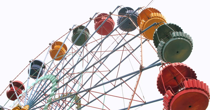 Colorful vintage Ferris wheel spinning slowly 