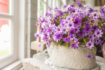 fake flowers on old stone Mill