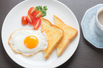 Plate of breakfast with fried eggs and bread
