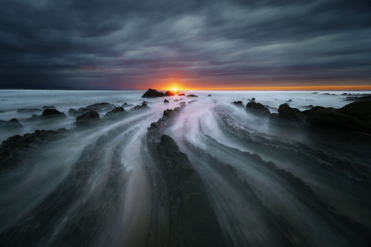 flysch rocks in barrika beach at sunset