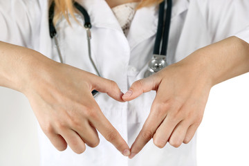 Doctor's hands making heart shape close up