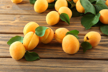 Ripe apricots on wooden table, closeup