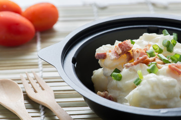 Potato salad on wood background