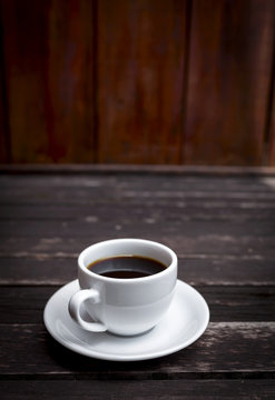 Hot coffee on dark wood floor