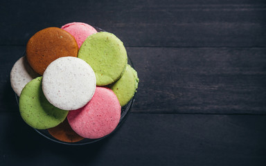 Colourful tasty macaroons on a wooden table