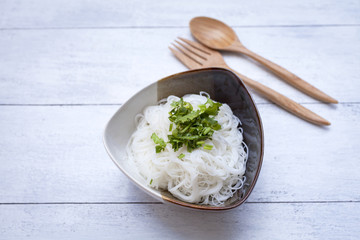 Plain noodle with vegetable on white wood background