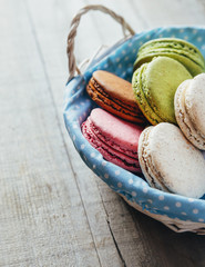 Colourful tasty macaroons on a wooden table