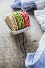 Colourful tasty macaroons on a wooden table