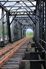 Fototapeta premium Old rail way bridge, Rail way construction in the country, Journey way for travel by train to any where. Old frame or construction. Concept go to success way.